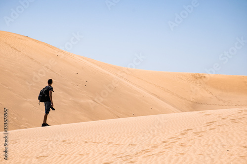 man in the desert with a camera