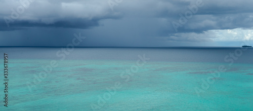 Tropical angry dark blue rain storm is approaching quickly over Indian ocean near Banyak islands  Sumatra. Perfect but still undiscovered holiday destination