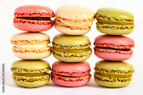 Assortment of delicious traditional french macaroons. Colorful sweet dessert for real gourmands. White background, copy space, close up, macro.