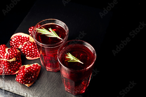 Pomegranate juice on a dark background. Summer drink. Pomegranate on a dark background.
