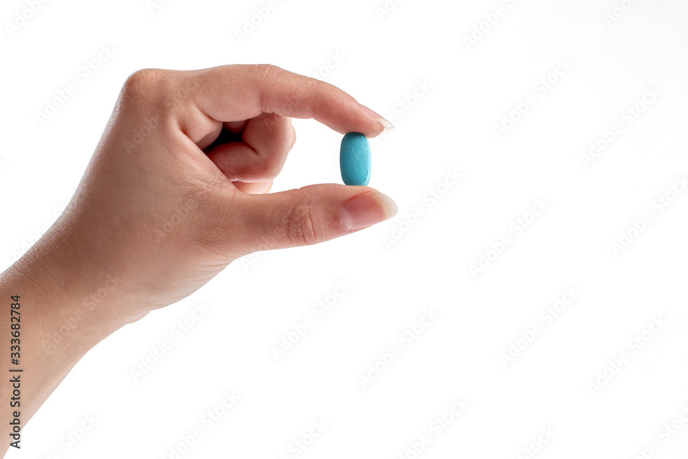Blue vitamine in thumbs hand. medicines and vitamins Blue vitamine in thumbs hand. medicines and vitamins