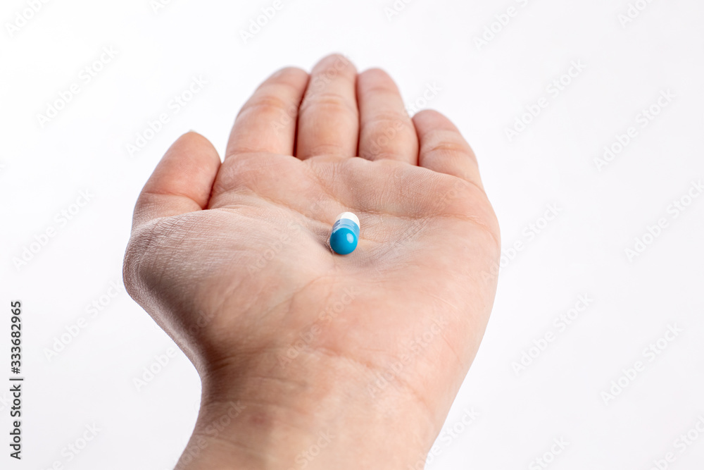 Blue and white pill in hand. medicines and vitamins Blue and white pill in hand. medicines and vitamins