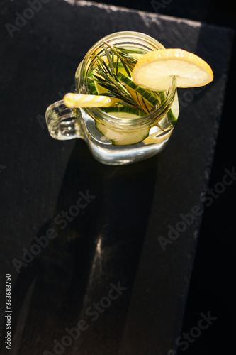 Lemonade on a dark background. Summer refreshing drink. View from above.