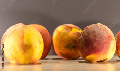 Fresh Peach Fruit (Prunus persica) on a flat surface