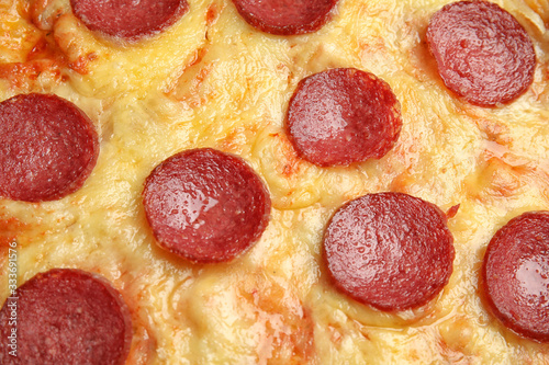 Tasty pepperoni pizza as background, closeup view