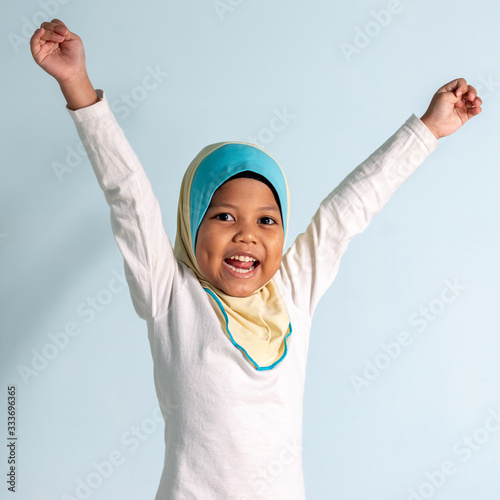 Happy Muslim girl wearing hijab isolated portrait.  Shallow depth of field