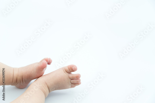 Cute baby feet on white background