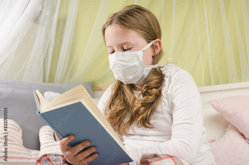 Girl reading a book during quarantine on the bed. Girl reading a book during quarantine on the bed.