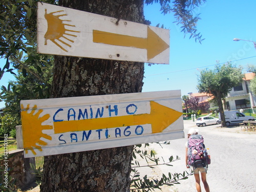 Pilgrim with scallop shell mark and yellow arrow sign, Camino de Santiago, Way of St. James, Journey from Vairao 〜 Barcelos, Portuguese way, Portugal
