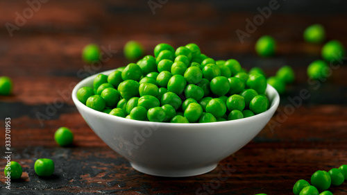 Green peas in white bowl. Healthy food © grinchh