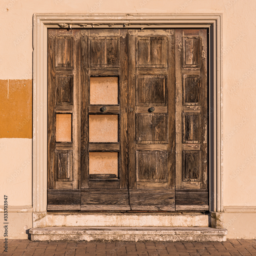 An old door on a derelict and abandoned building in Senigallia, Italy