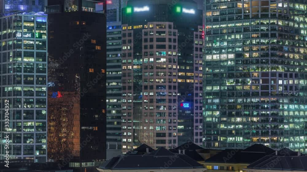 Aerial cityscape of Singapore downtown of modern architecture with illuminated skyscrapers night timelapse, view from above in chinatown district with glowing windows in towers Aerial cityscape of Singapore downtown of modern architecture with illuminated skyscrapers night timelapse, view from above in chinatown district with glowing windows in towers