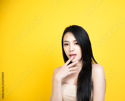 portrait asian woman smile face with yellow background