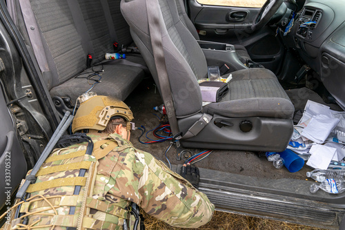 A U.S. Army soldier searches a vehicle for improvised explosive devices