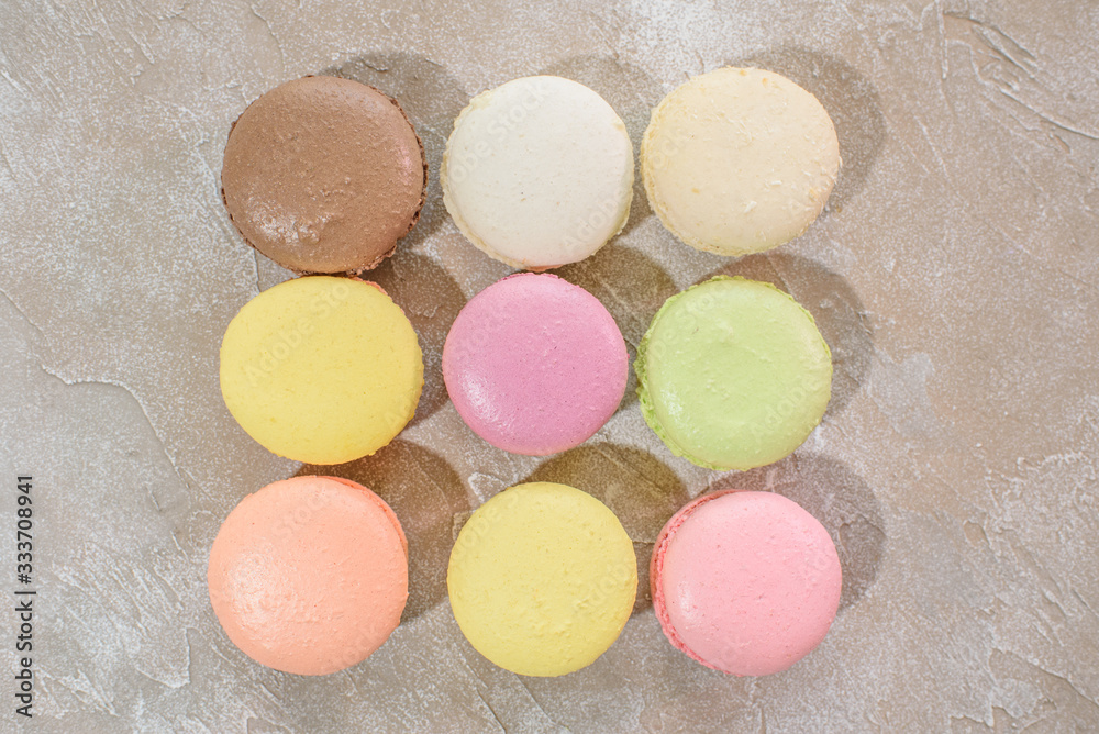 Obraz premium Macarons on a concrete background. Isolates. Multi-colored. Beautiful background.
