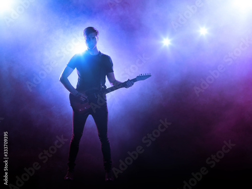 Singer with a guitar performing on a stage