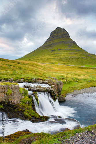 Waterfall and lake with Kirkjufell mountain in the background