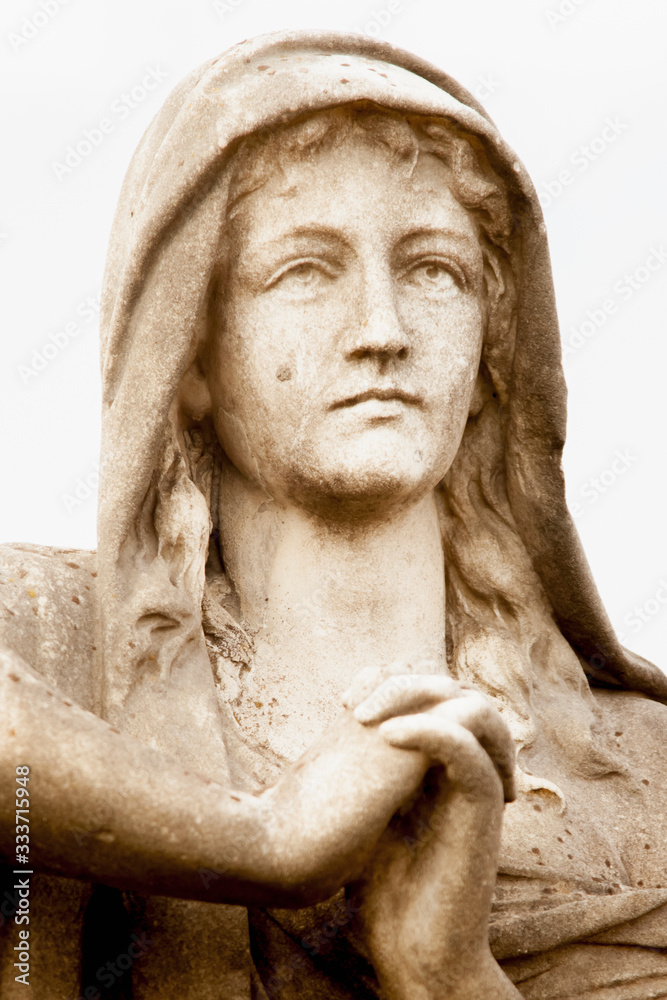 Fragment of ancient stone statue of Mary Magdalene praying. Faith, religion, God concept. Fragment of ancient stone statue of Mary Magdalene praying. Faith, religion, God concept.