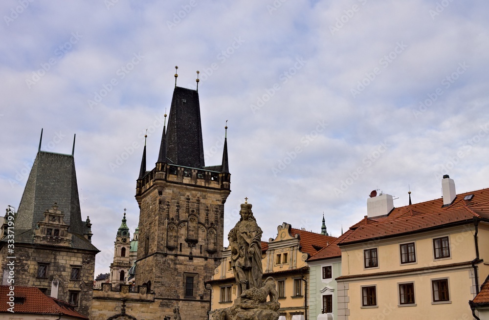 The Lesser Town Bridge Tower and the statues on the Charles Bridge (Prague, Czech Republic, Europe)