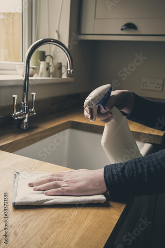 Fotografía Cleaning and sanitising a kitchen with anti bacterial spray
