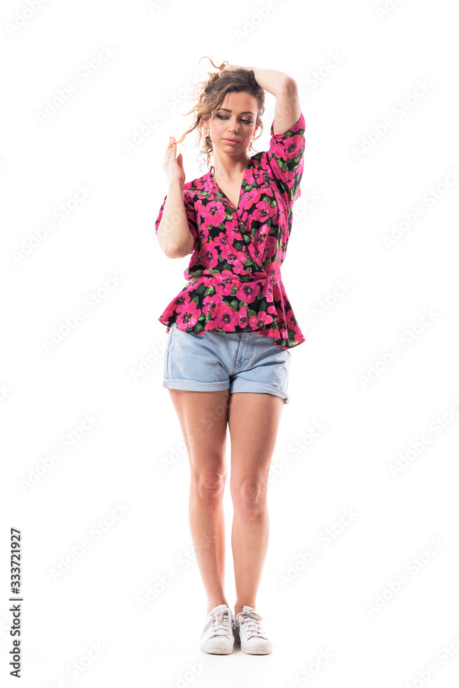 Thoughtful young beautiful woman twisting hair looking down having naughty ideas. Full body isolated on white background. Thoughtful young beautiful woman twisting hair looking down having naughty ideas. Full body isolated on white background.
