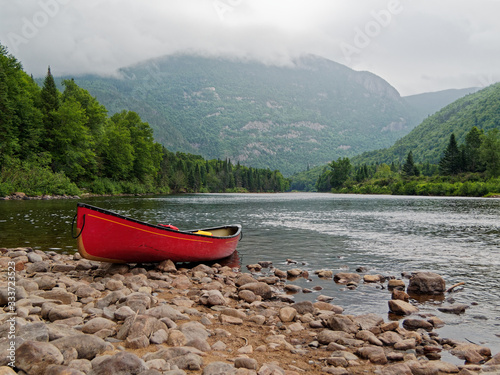 Canoeing on a river in a red canoe in summer in Hautes-Gorges-de-la-Rivière-Malbaie National Park