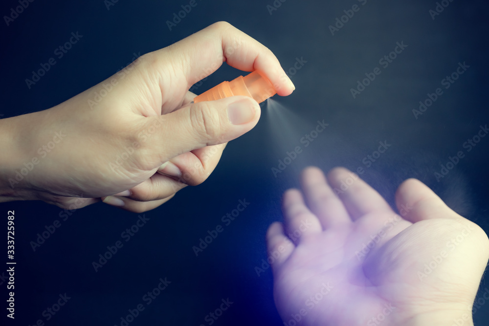 Hand of lady that applying alcohol spray or anti bacteria spray to prevent spread of germs, bacteria and corona virus or COVID-19. Hand of lady that applying alcohol spray or anti bacteria spray to prevent spread of germs, bacteria and corona virus or COVID-19.