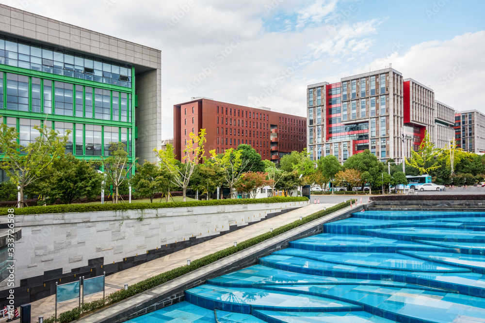 Park with trees and fountains in front of the Business Center Park with trees and fountains in front of the Business Center