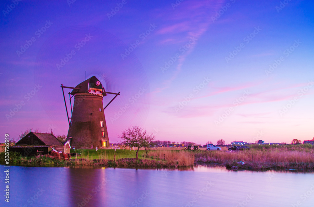 breathtaking beautiful inspirational landscape with windmills in Kinderdijk, Netherlands at sunset.