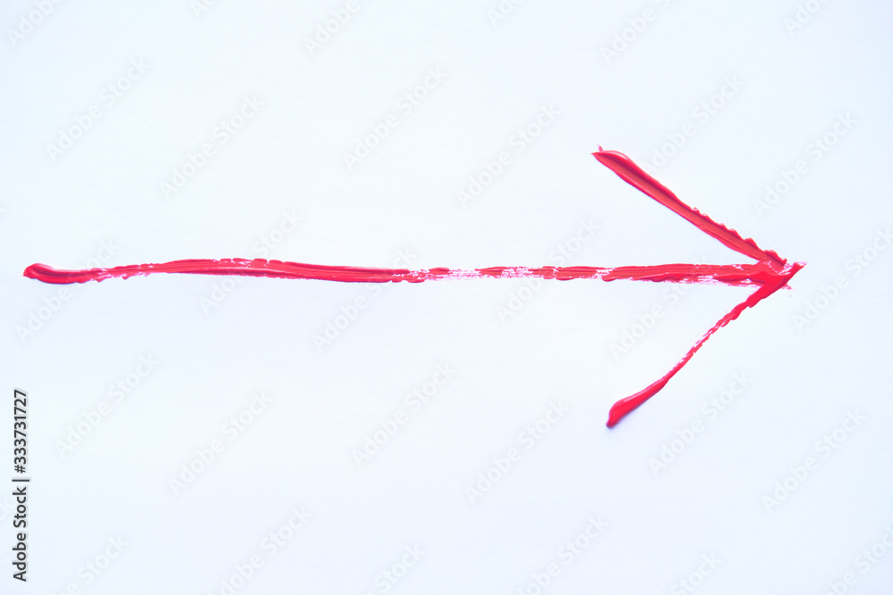 Red hand painted arrow with brush strokes isolated on the white background. Red hand painted arrow with brush strokes isolated on the white background.
