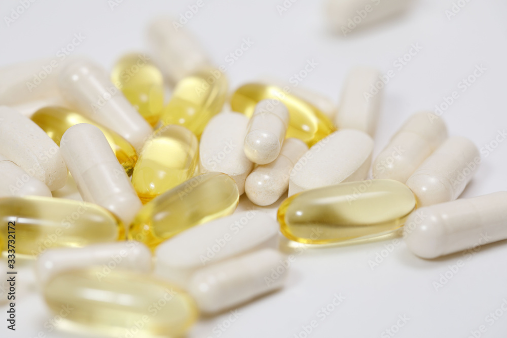 pills and vitamins on a white background pills and vitamins on a white background