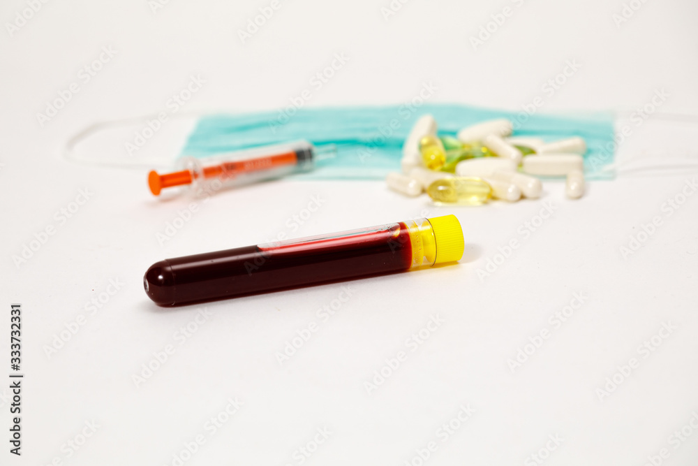 syringe for injection and test tube with blood, pills on a white background syringe for injection and test tube with blood, pills on a white background
