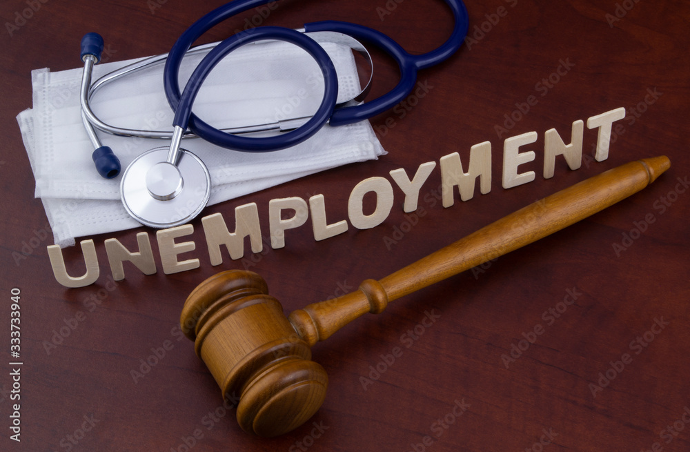 Unemployment because pandemic time concept. Judge gavel, masks and stethoscope on table. Unemployment because pandemic time concept. Judge gavel, masks and stethoscope on table.