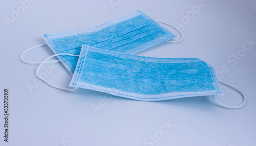 Two blue protective disposable medical masks