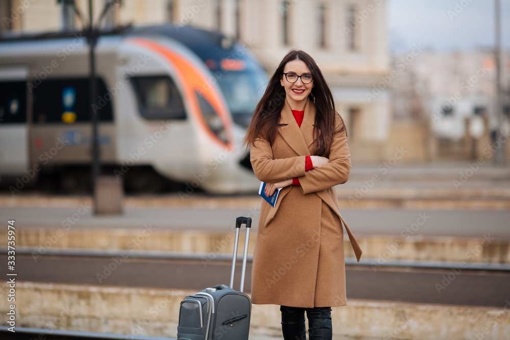 Young beautiful business woman suitcase in urban setting Young beautiful business woman suitcase in urban setting