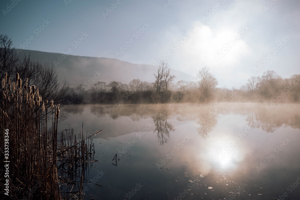 Mystical lake on a foggy morning