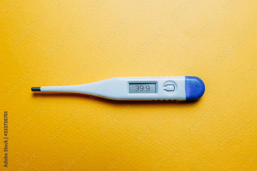 Thermometer with high temperature and pills on orange background. Vaccine against coronavirus. Thermometer with high temperature and pills on orange background. Vaccine against coronavirus.