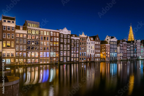 Amsterdam Night cityscape - Houses on Damrak canal at twilight