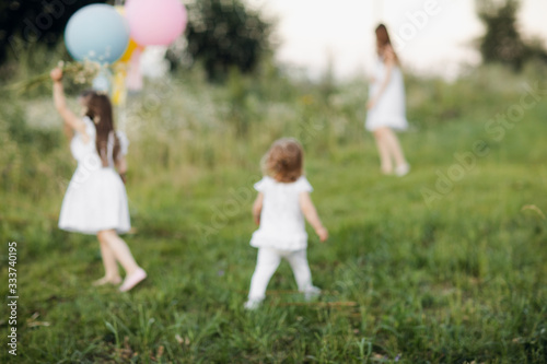 Blurred background of family in nature, back view