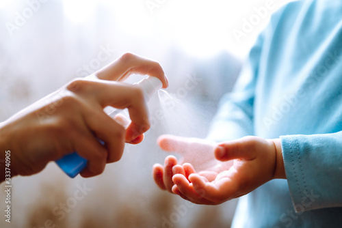 Hands with sanitizer antiseptic. Mother and child using sanitize antiseptic for hand coronavirus protection.Hygiene concept. Prevent spread of germs and bacteria and avoid infections coronavirus.