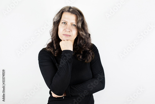 Beautiful woman on light background with serious but satisfied face. One can see that a woman is happy and content with life, good that she is healthy © Мар'ян Філь