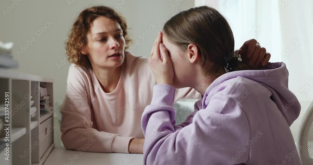 Worried young mum comforting solacing upset crying teenage daughter at home. Caring parent adult mother consoling depressed adolescent child, talking to teen girl giving love, advice, support concept. Worried young mum comforting solacing upset crying teenage daughter at home. Caring parent adult mother consoling depressed adolescent child, talking to teen girl giving love, advice, support concept.