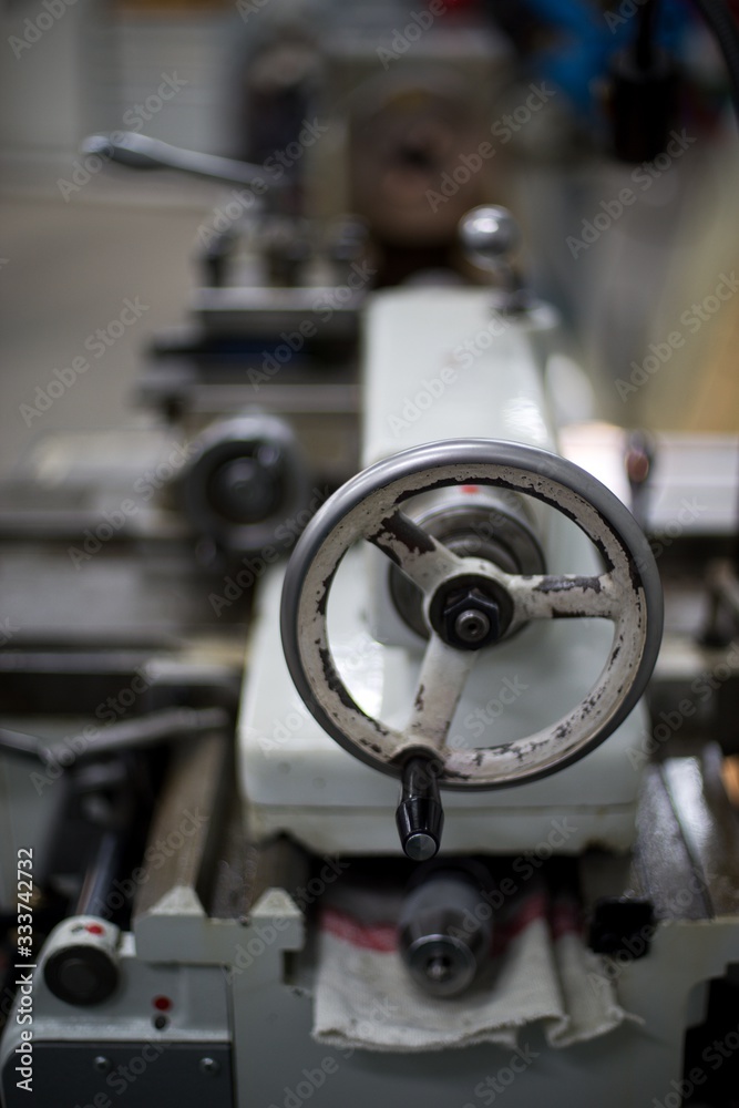Abandoned machine metalworking lathe in a factory closing due to the pandemic virus