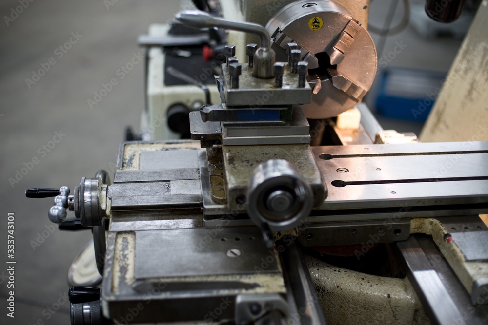 Abandoned machine metalworking lathe in a factory closing due to the pandemic virus Abandoned machine metalworking lathe in a factory closing due to the pandemic virus