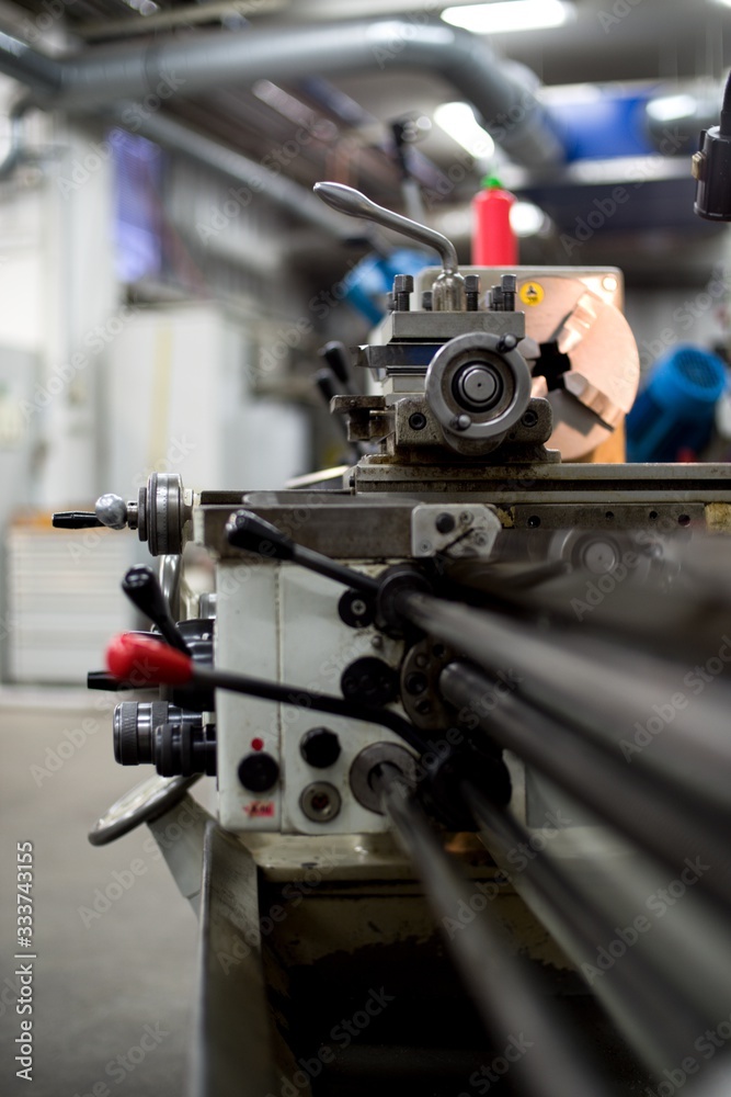 Abandoned machine metalworking lathe in a factory closing due to the pandemic virus