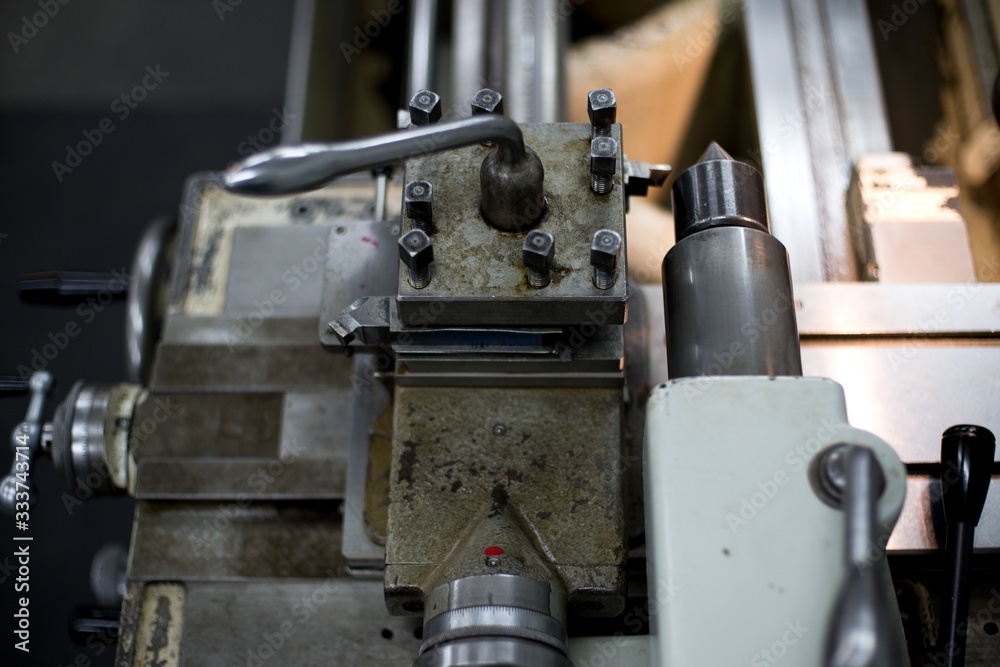 Abandoned machine metalworking lathe in a factory closing due to the pandemic virus Abandoned machine metalworking lathe in a factory closing due to the pandemic virus