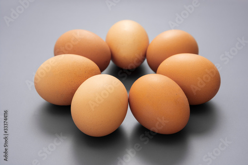 Raw eggs isolated on grey background, protein food.