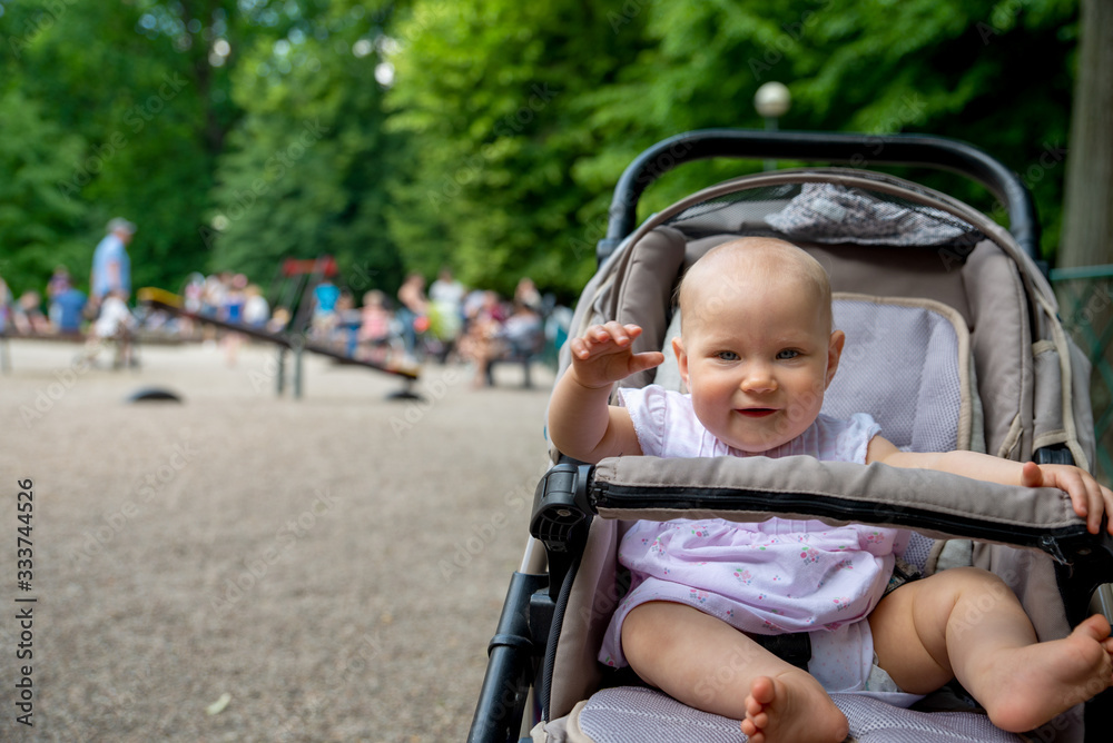 a small child on the playground in a pram a small child on the playground in a pram