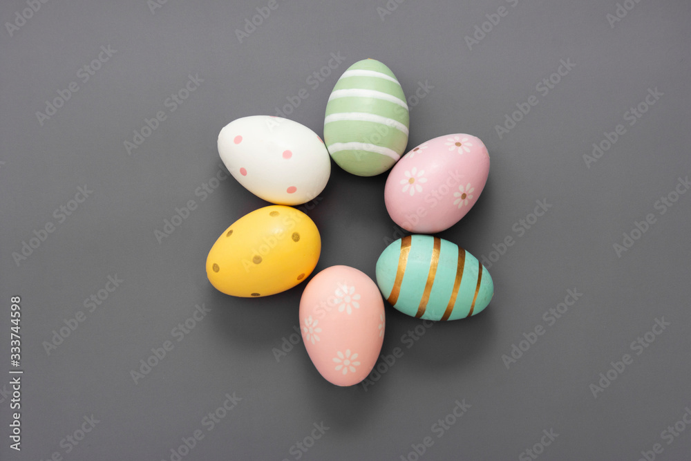 Easter decorative colorful eggs. Grey background, top view, copy space.