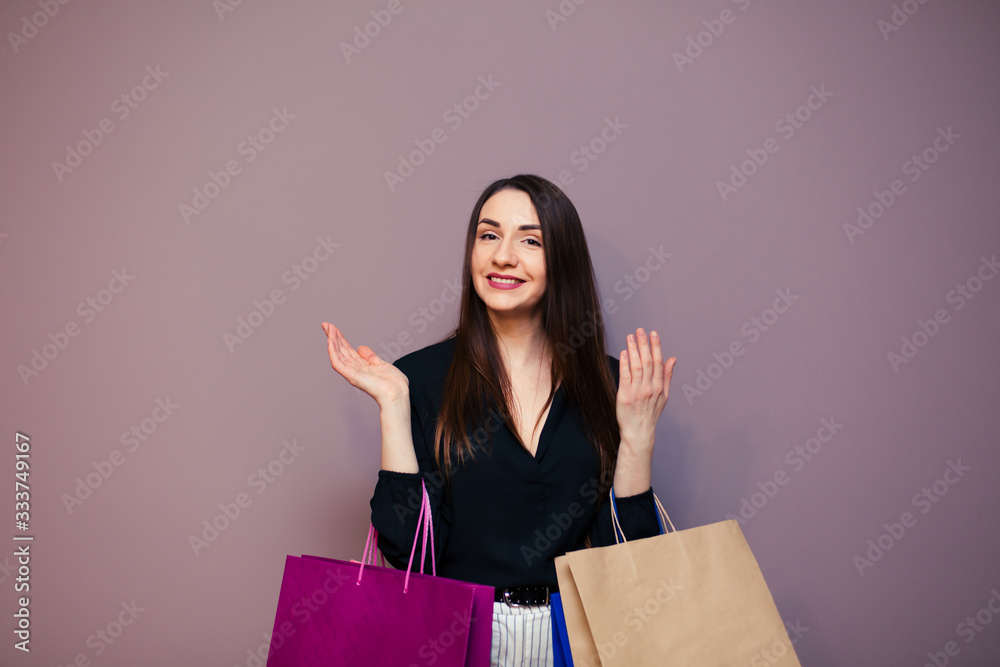 Black Friday sale concept for the store. Shopping woman in sunglasses holding bag isolated on dark background. Black Friday sale concept for the store. Shopping woman in sunglasses holding bag isolated on dark background.